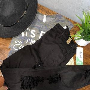 Distressed vibrant black jeans